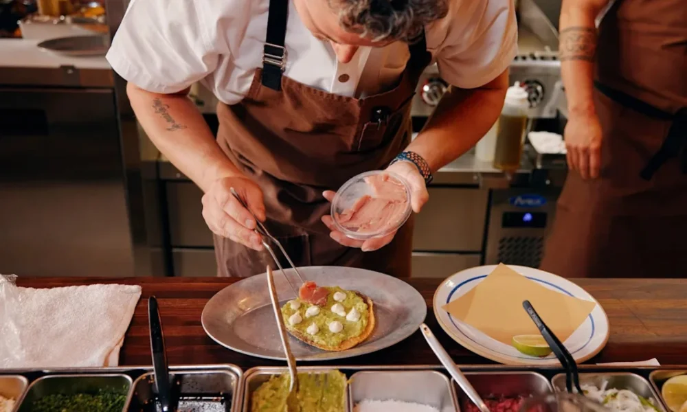 Chef plating tuna on avocado toast