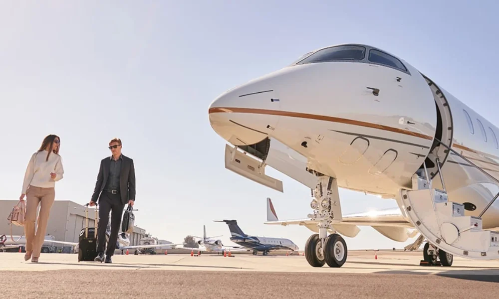 Couple with luggage walking toward private jet
