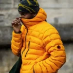 Man in orange puffer jacket and beanie