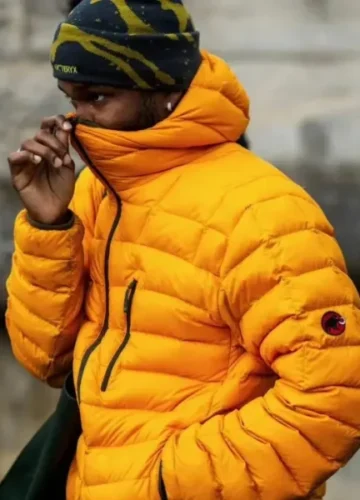 Man in orange puffer jacket and beanie