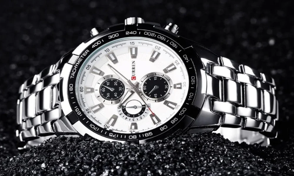 Silver chronograph watch on black glitter