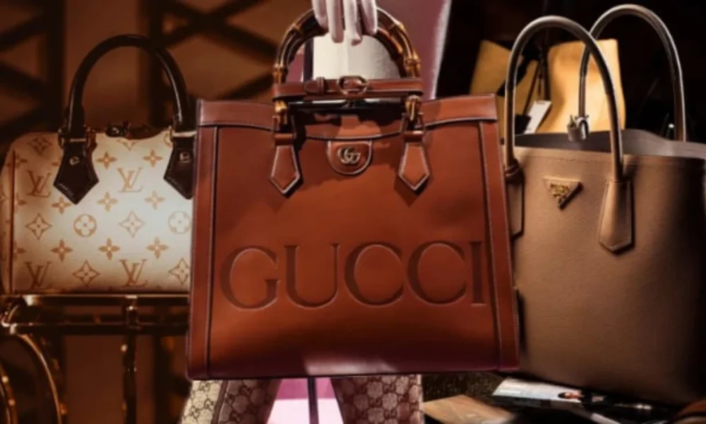 Three luxury handbags: Louis Vuitton, Gucci, Prada