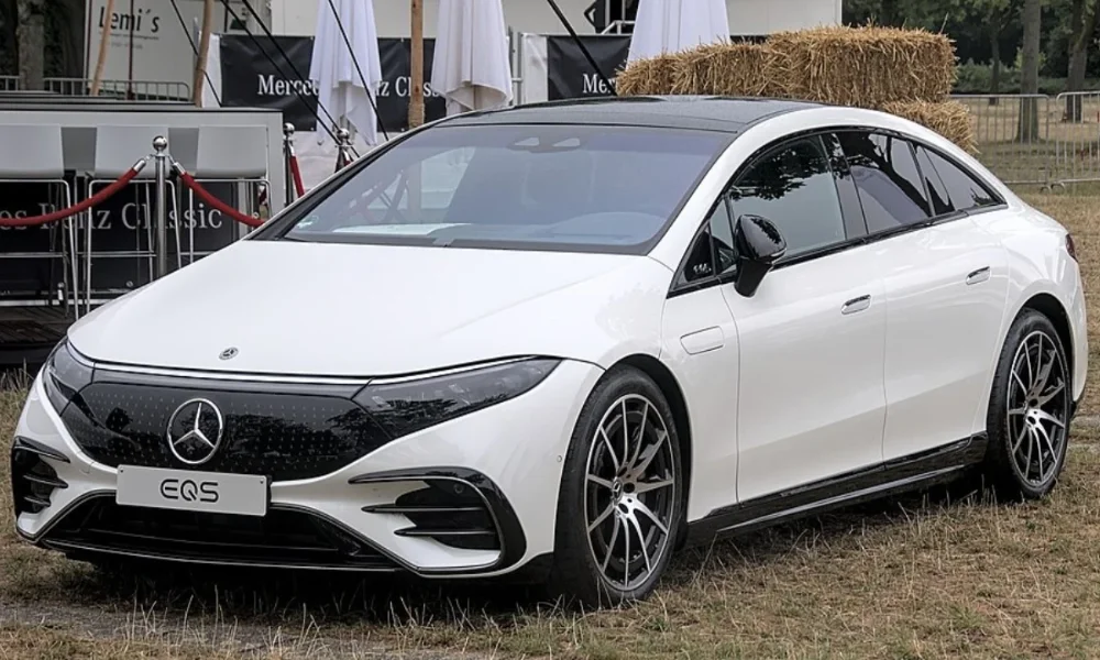 White Mercedes-Benz EQS electric car on grass