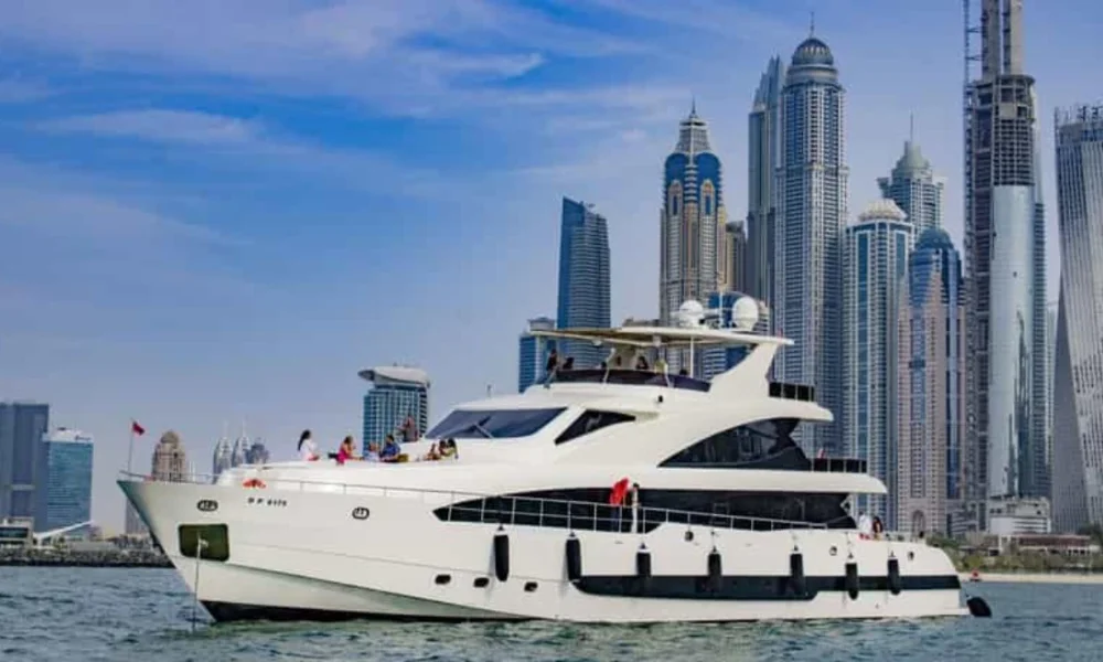 White yacht with people, city skyline