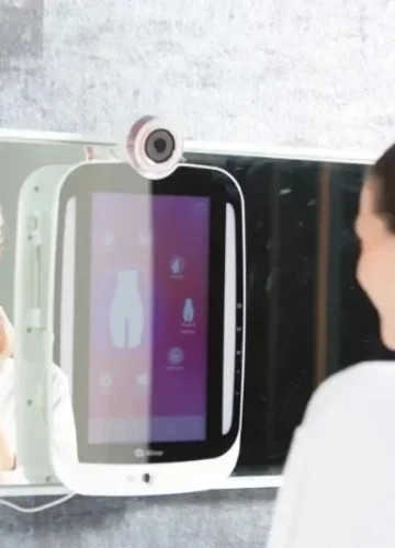 Woman in robe looking at smart mirror