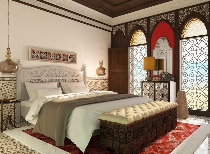 Ornate Arabic luxury bedroom interior with an intricately carved white headboard, traditional hanging glass pendant lights, a premium tufted bed bench, and pattern tiles