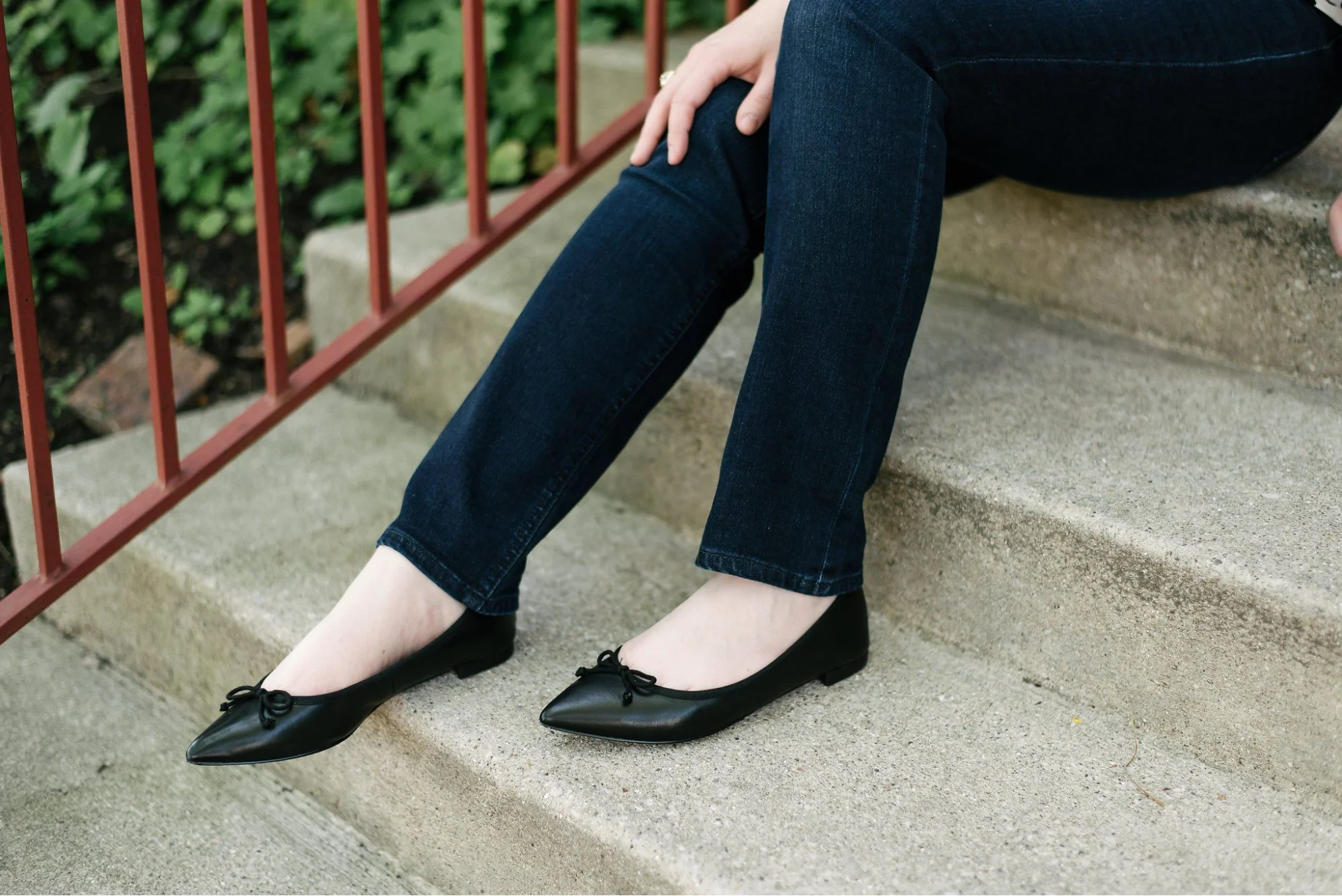 Close up of flat footwear paired with denim trousers