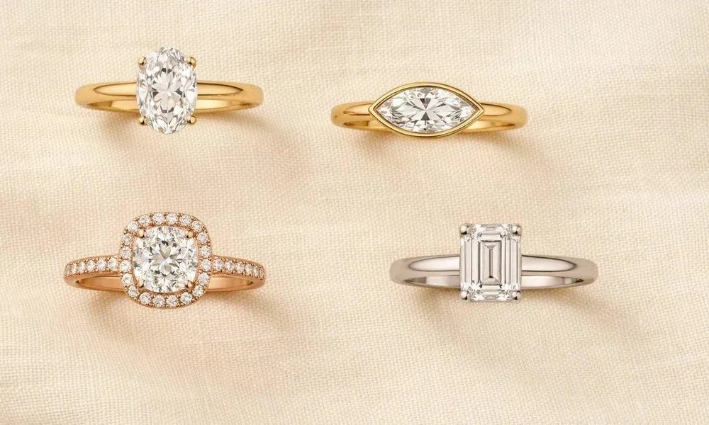 Round solitaire diamond engagement ring on a woman's hand.