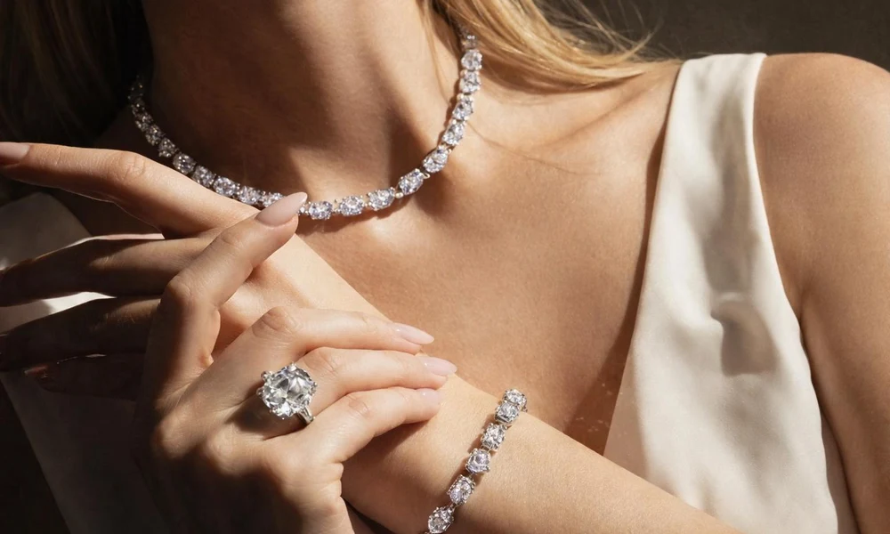 Statement diamond line necklace, large solitaire ring, and diamond bracelet.