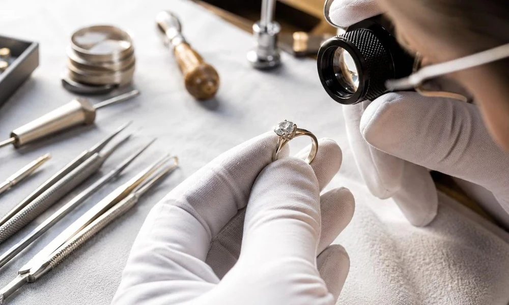 Jeweler inspecting diamond ring quality using a loupe.