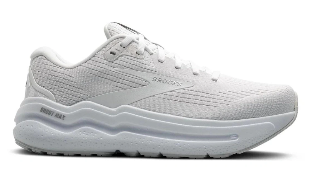 A white Brooks running shoe in side profile, featuring a breathable textured upper, cushioned sole, and clean modern design against a plain background.