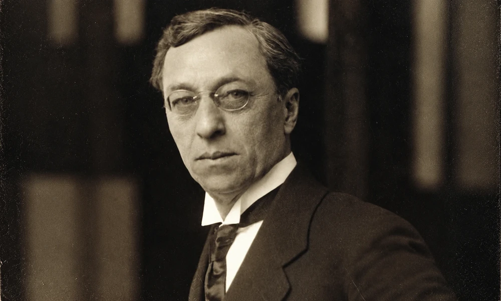 Sepia photo of abstract art pioneer Wassily Kandinsky (1866–1944) wearing round glasses and a dark suit-15 Greatest Painters
