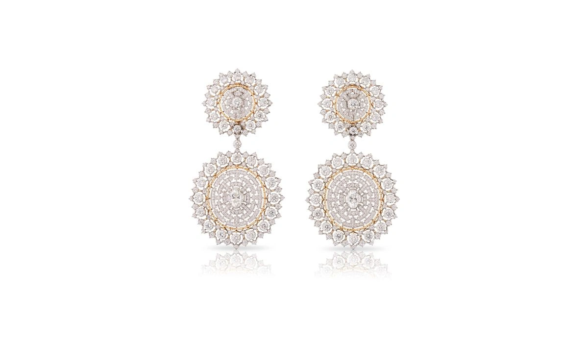 A pair of elegant diamond drop earrings against a white background.
