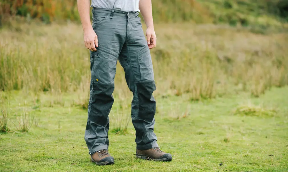 A person in gray cargo trousers and rugged brown boots-Best Waterproof Hiking Pants