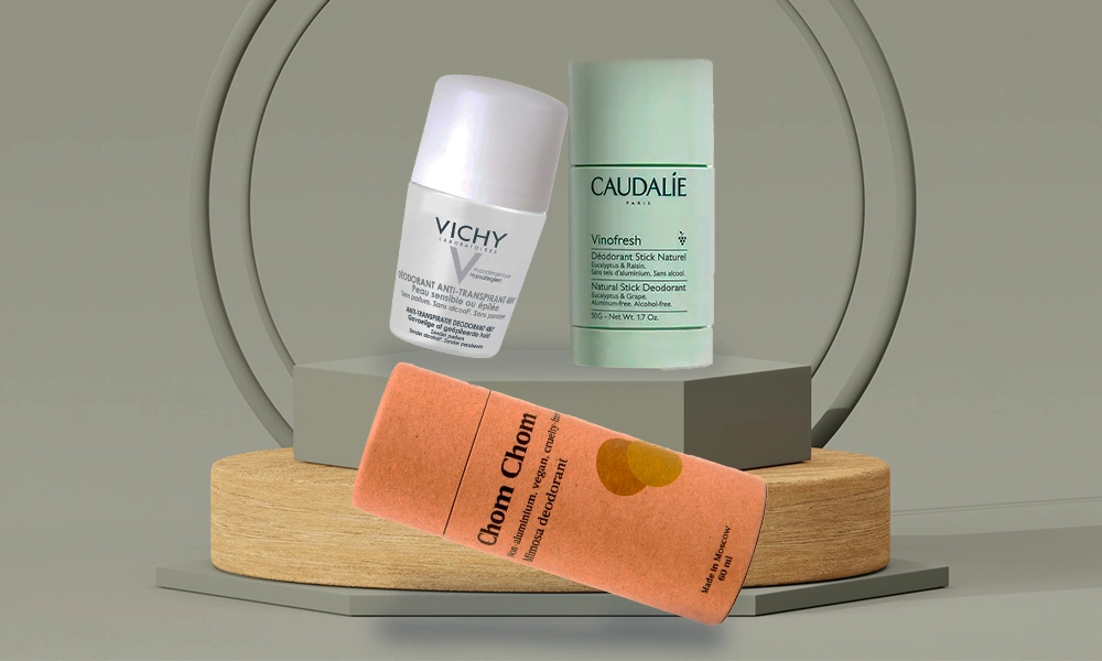 Vichy and Caudalie skincare bottles stand behind an orange skincare tube on wood and gray display blocks-Best Body Care Products