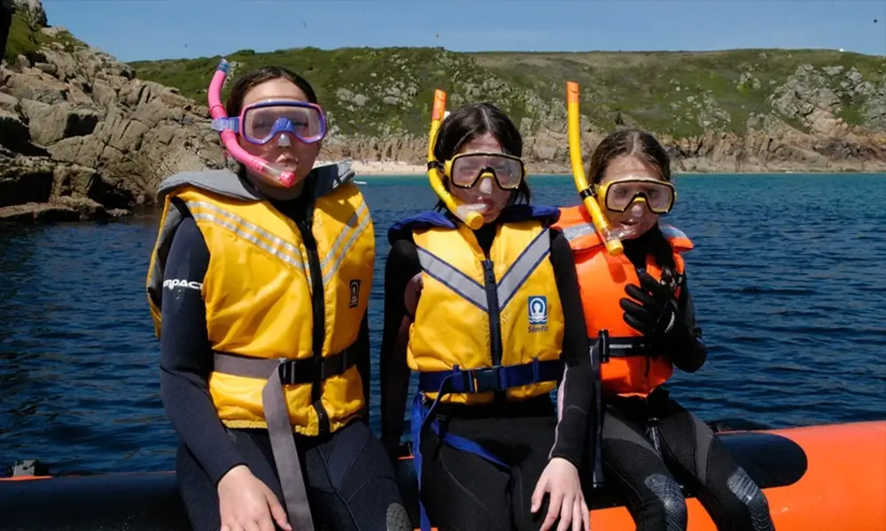 Three snorkelers in bright life vests-Best Places to Snorkel