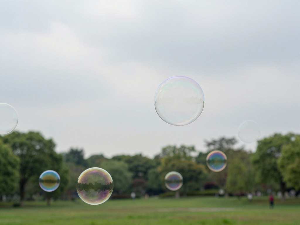 Giant bubbles drift outdoors on a calm overcast day Giant bubbles drift outdoors on a calm overcast day
