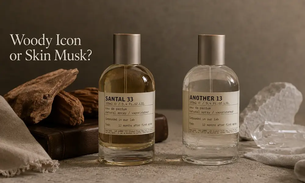 Two perfume bottles labeled Santal 33 and Another 13 sit among wood and pale stones beneath the words “Woody Icon or Skin Musk?”, evoking a warm, minimalist mood.