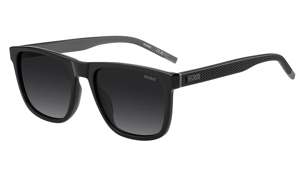 Black Hugo Boss rectangular sunglasses with dark gradient lenses and textured temples, shown open against a white background; sleek, modern styling.