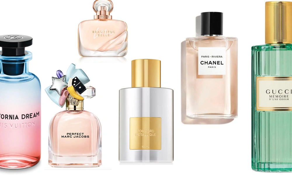 Five luxury perfume bottles in pink, clear, and green glass, featuring Chanel, Gucci, Marc Jacobs, and other labels. The polished display feels elegant and glamorous.
