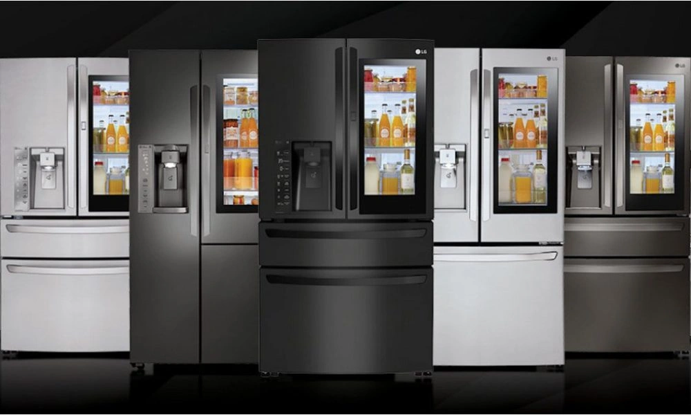A showroom lineup of sleek stainless-steel and black refrigerators, with lit shelves of food and drinks, ice dispensers, and a modern, polished look.