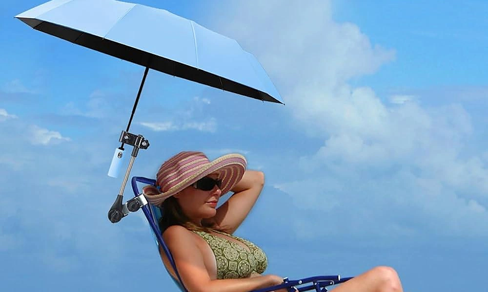 Clip-on umbrella providing personal shade on a beach chair