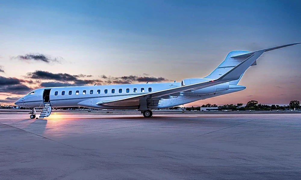 Bombardier Global 7500 long-range private jet parked with its airstair deployed at dusk
