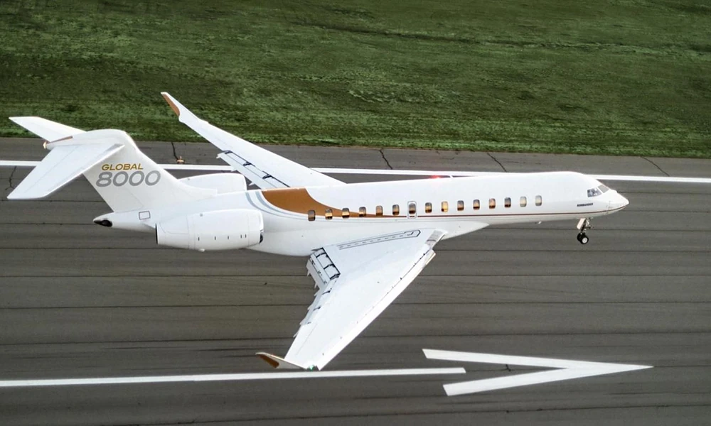 Bombardier Global 8000 high-speed private jet touching down on an airport runway