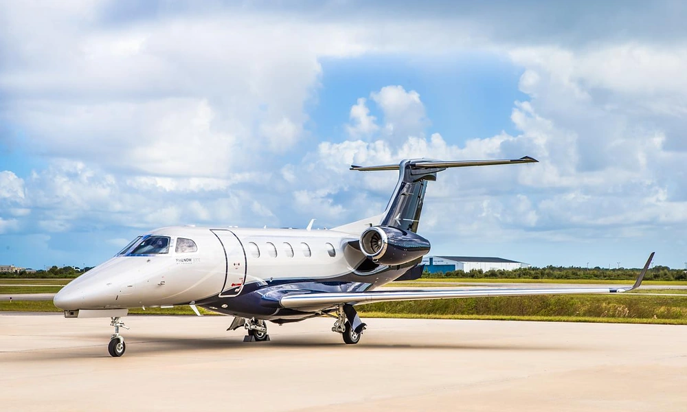 Embraer Phenom 300E light jet parked on an airport apron, frequently used for regional New York private jet flights