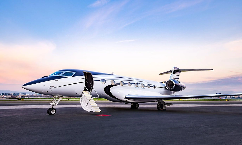 Gulfstream G650ER long-range business aircraft parked with open entry door during golden hour