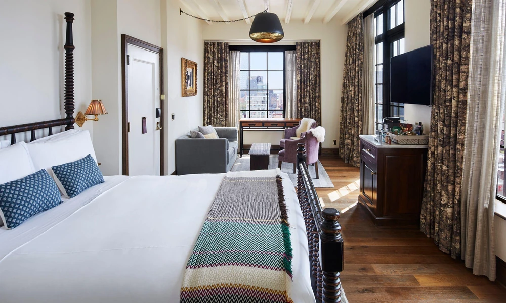 Warm boutique hotel room with industrial-inspired details.