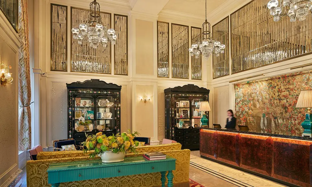 Eclectic luxury hotel interior with rich colors and decorative details.