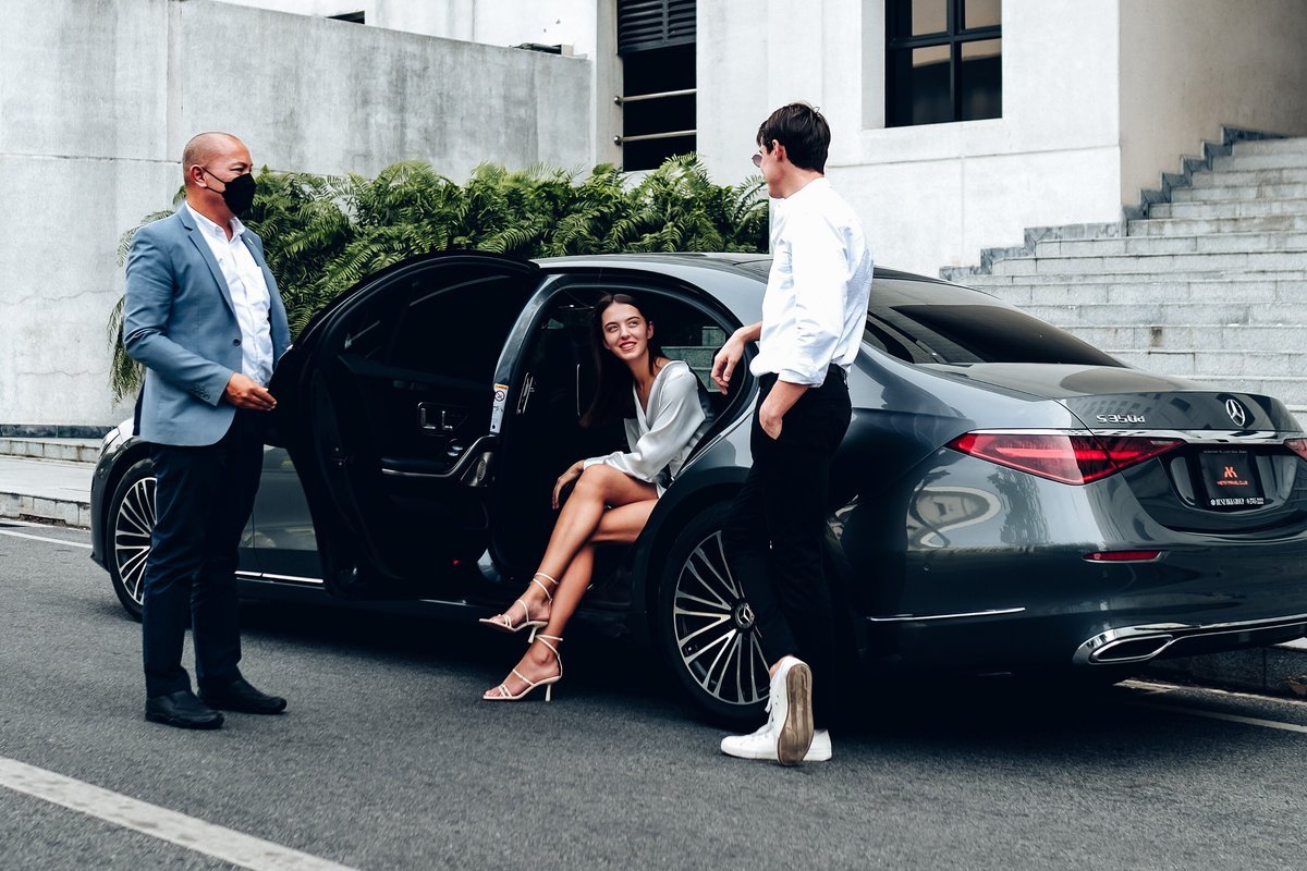 Chauffeur service greeting a passenger at a luxury car