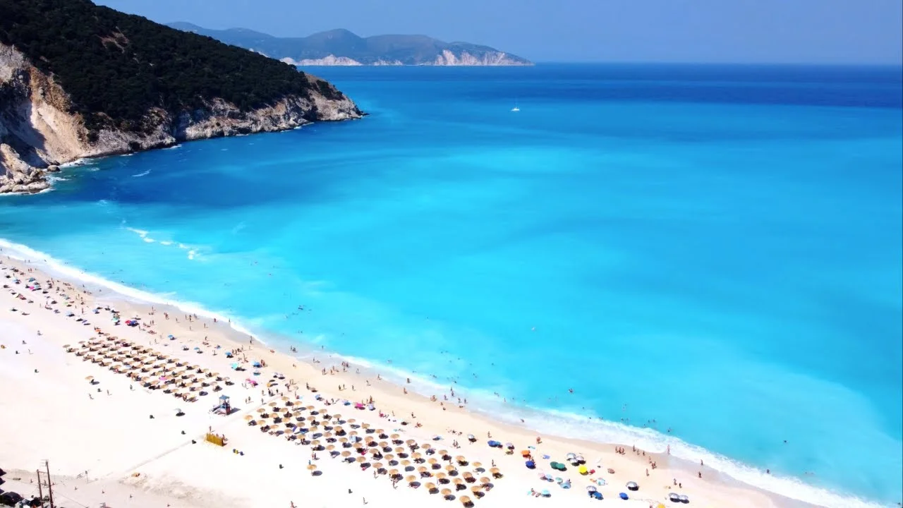 Vibrant turquoise sea washing onto a sandy beach