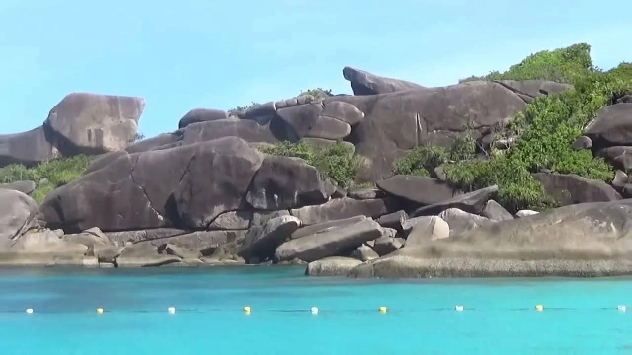 Unique rock formations along clear turquoise water