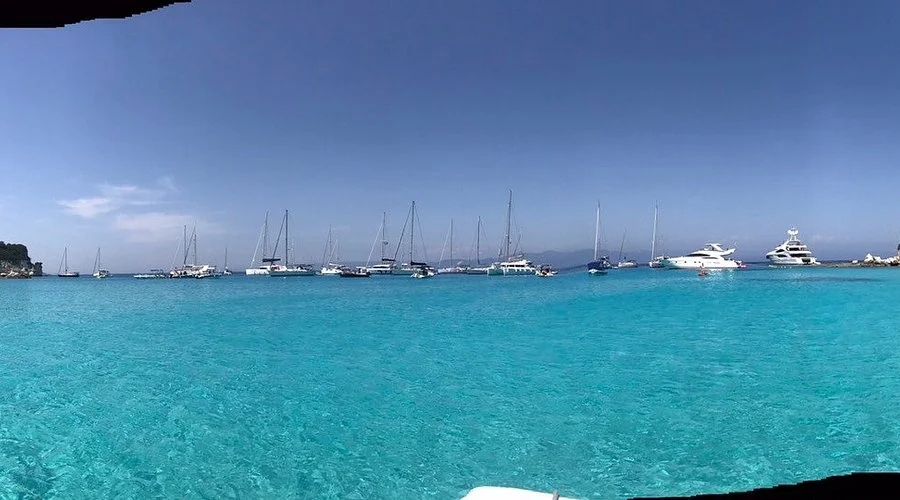 Boats anchored along a scenic island shoreline