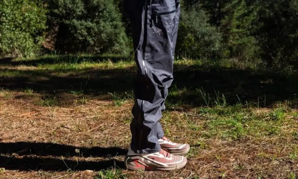 A man is wearing Arc’teryx Beta Pant that is showing the fabric and its quality.