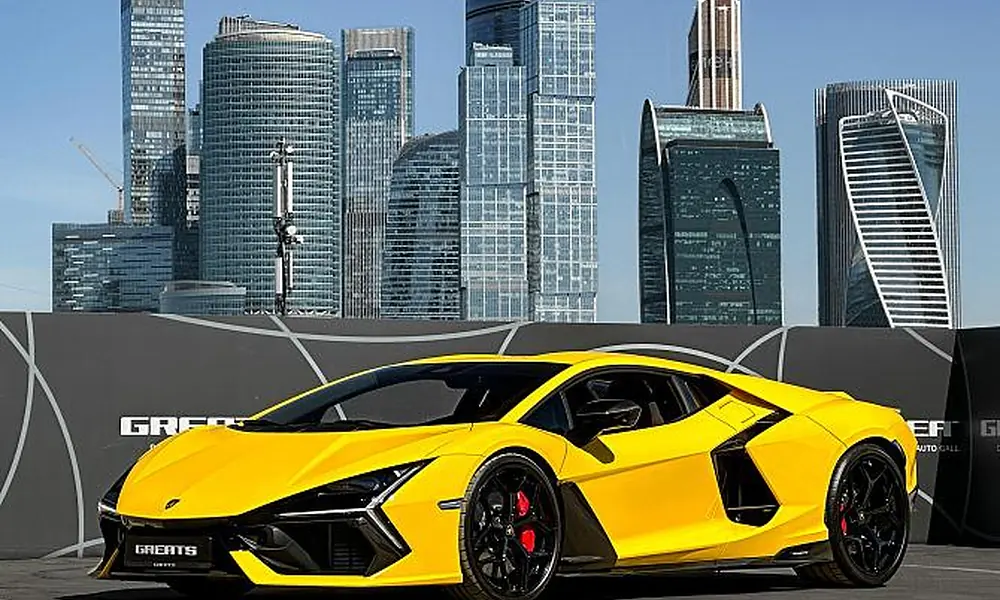 Bright yellow Lamborghini Revuelto displayed against modern glass skyscrapers-Most Luxurious Cars in New York