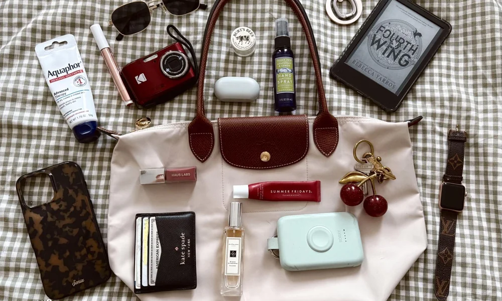 Everyday tote bag with a notebook, wallet, sunglasses, and travel essentials.