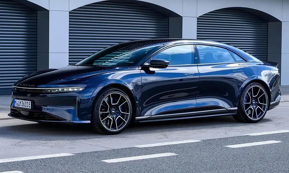 Dark blue Lucid Air Sapphire electric luxury sedan parked near modern garage doors-Most Luxurious Cars in New York
