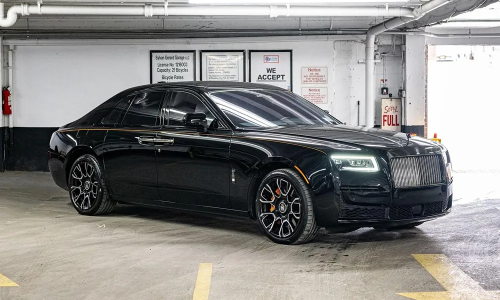 Black sedan parked inside a Manhattan garage, highlighting the cost of owning a New York luxury car