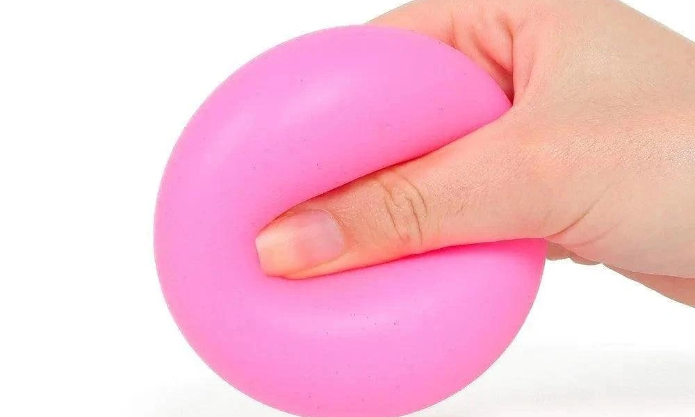Single thumb pressing firmly into a smooth matte pink round squeezable stress ball