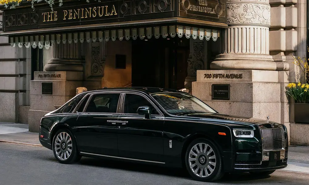 Dark green Rolls-Royce Phantom representing traditional luxury cars in New York outside a Fifth Avenue hotel