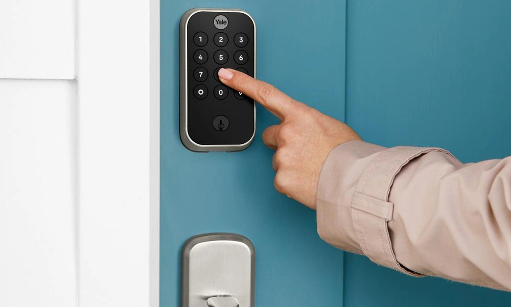 Yale-style touchscreen smart lock on a modern front door.