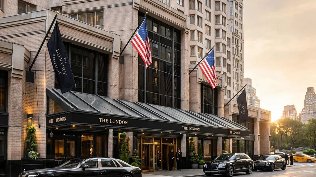 The London Luxury Collection Hotel Manhattan Midtown exterior entrance with The London awning, Luxury Collection flags and luxury cars at 54th Street